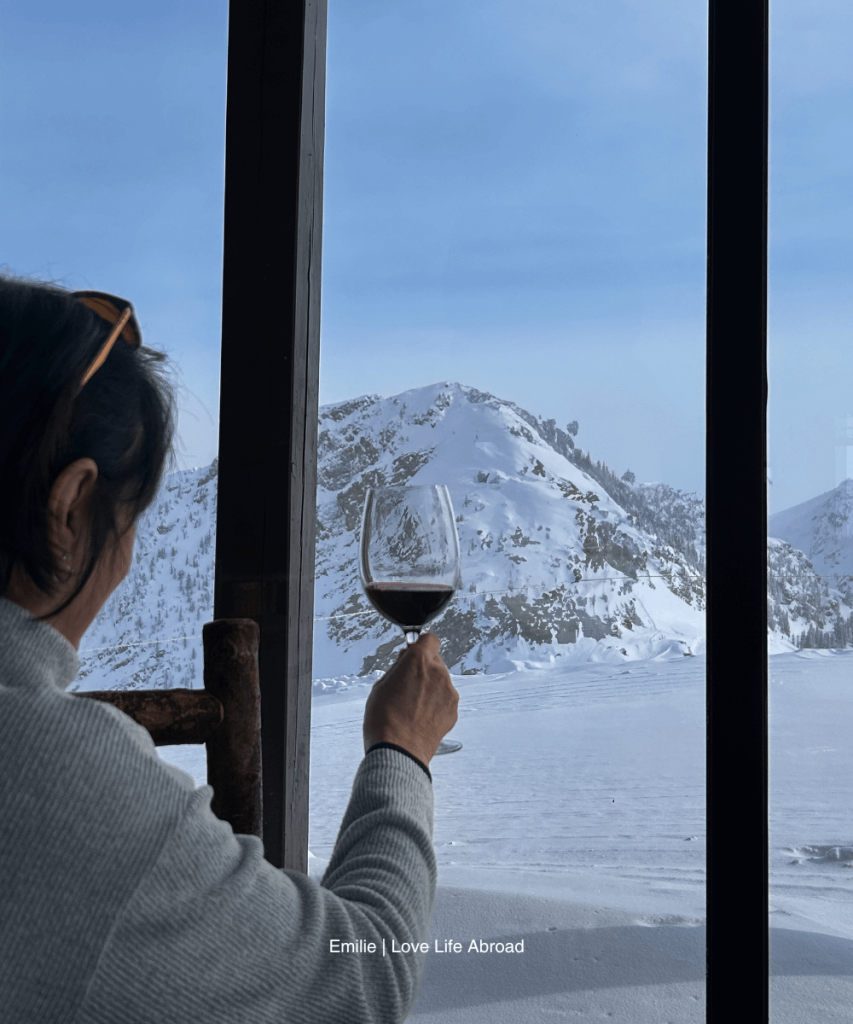 My mom posing by the big windows at the Eagle's Eye Restaurant at the top of the gondola at Kicking Horse