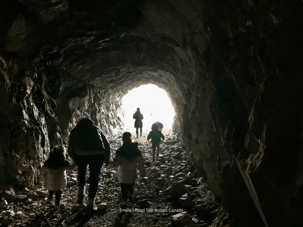 Family walking in the bunker at Heart Creek Bunker in Kananaskis, one of the best stops between Calgary and Banff on the Trans-Canada Highway
